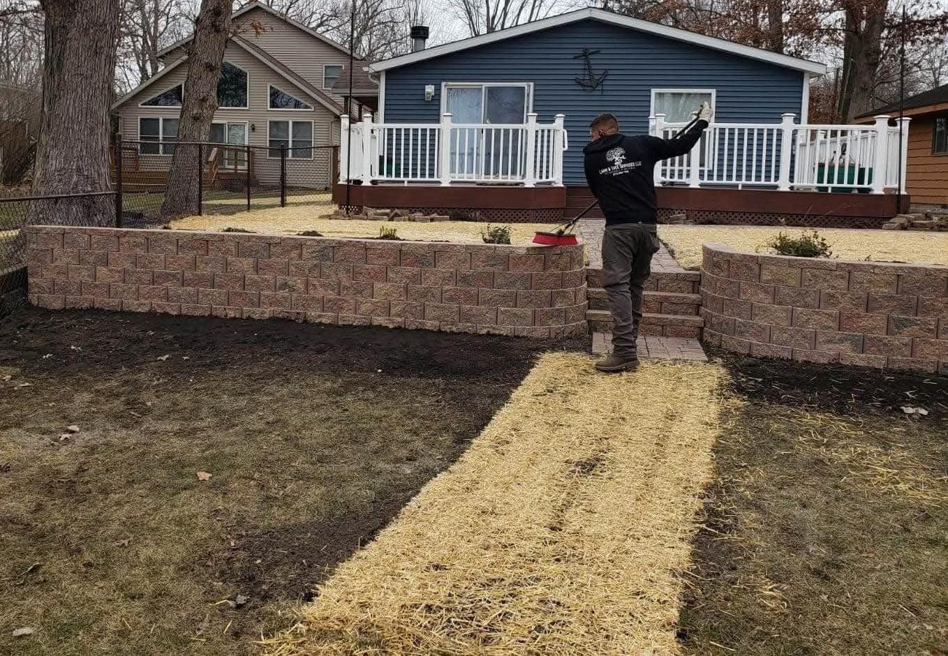 Curved block retaining walls with steps, fresh seed and straw